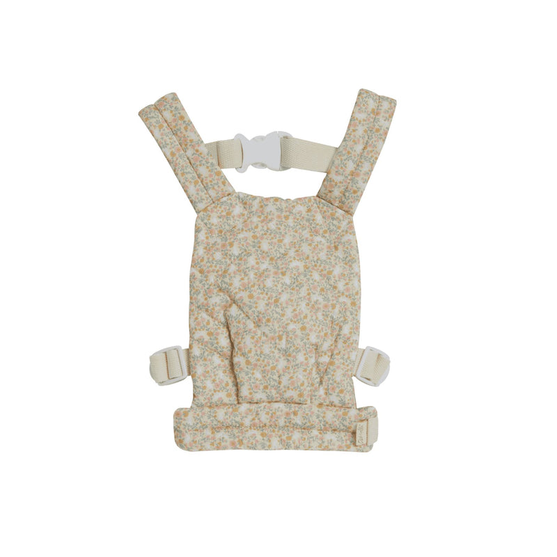 A beige floral-patterned Olli Ella Doll Carrier with padded straps designed for carrying dolls.